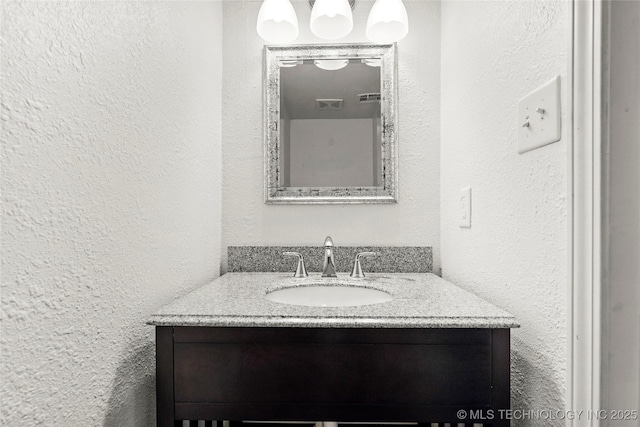 7911 E 66th St Unit 45H, Tulsa, OK 74133 - bathroom featuring vanity and a textured wall