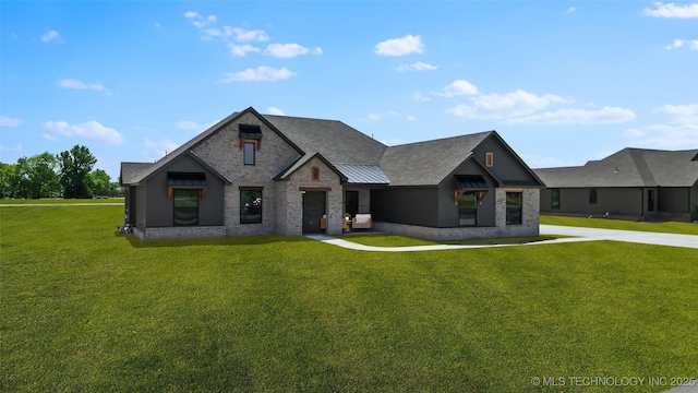 16306 E 102nd St, Owasso, OK 74055 - view of front of home featuring a front yard, a standing seam roof, and metal roof