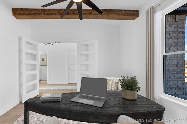 16306 E 102nd St, Owasso, OK 74055 - home office featuring beam ceiling, ceiling fan, light wood finished floors, built in shelves, and baseboards