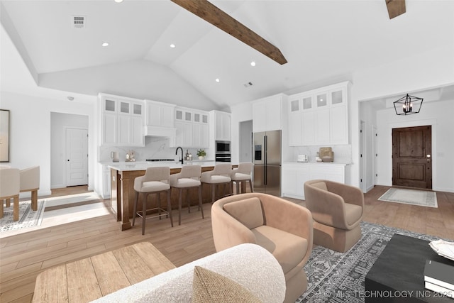 16306 E 102nd St, Owasso, OK 74055 - living area featuring light wood-style floors, high vaulted ceiling, and recessed lighting