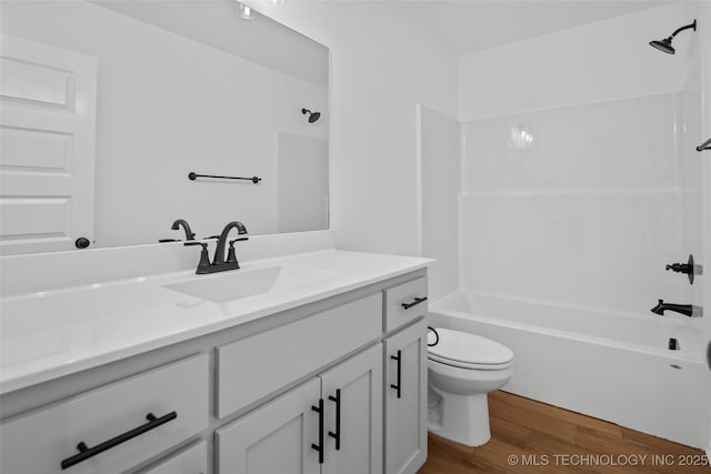 11412 E 93rd Pl, Owasso, OK 74055 - full bathroom with wood finished floors, toilet, vanity, and bathtub / shower combination