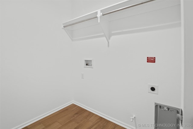 11412 E 93rd Pl, Owasso, OK 74055 - laundry area featuring washer hookup, wood finished floors, hookup for an electric dryer, baseboards, and gas dryer hookup