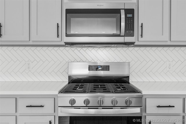 11412 E 93rd Pl, Owasso, OK 74055 - kitchen view of stainless steel appliances, light countertops, and backsplash