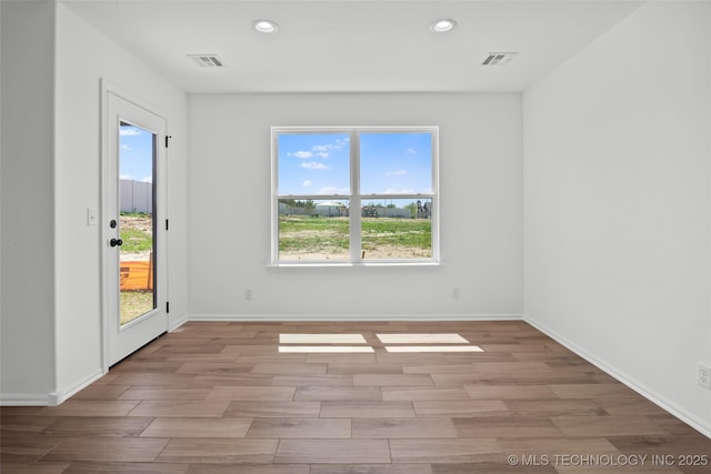 11412 E 93rd Pl, Owasso, OK 74055 - spare room featuring recessed lighting, wood finished floors, and baseboards