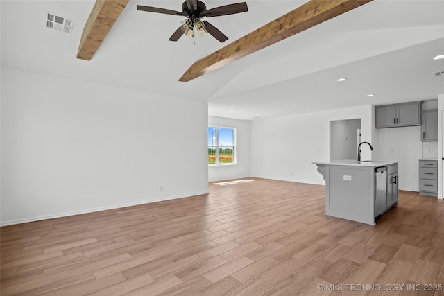 11412 E 93rd Pl, Owasso, OK 74055 - kitchen featuring gray cabinetry, open floor plan, stainless steel dishwasher, light countertops, and a sink