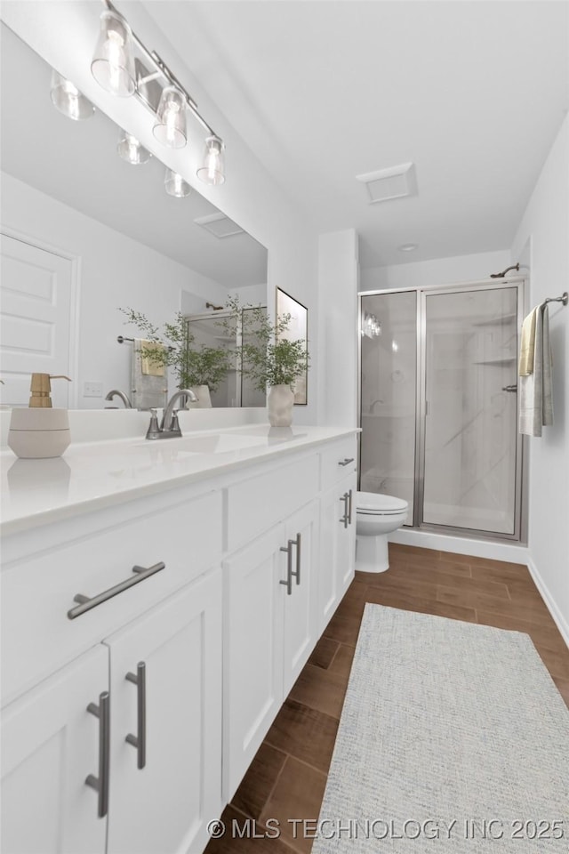 11502 E 94th Pl, Owasso, OK 74055 - full bathroom with toilet, vanity, a stall shower, and wood finished floors