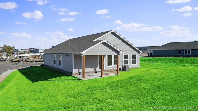 11502 E 94th Pl, Owasso, OK 74055 - rear view of house featuring a lawn, a patio, central AC, and roof with shingles