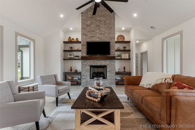 18258 S Clear Creek Ct, Claremore, OK 74017 - living area featuring a ceiling fan, light wood-type flooring, lofted ceiling, a fireplace, and built in shelves