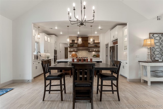 18258 S Clear Creek Ct, Claremore, OK 74017 - dining area with a chandelier, light wood finished floors, high vaulted ceiling, baseboards, and recessed lighting