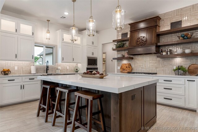18258 S Clear Creek Ct, Claremore, OK 74017 - kitchen featuring open shelves, decorative backsplash, a sink, a kitchen island, and recessed lighting