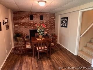 1417 Leisure Rd, Grove, OK 74344 - dining space with a paneled ceiling, wood finished floors, stairway, and baseboards