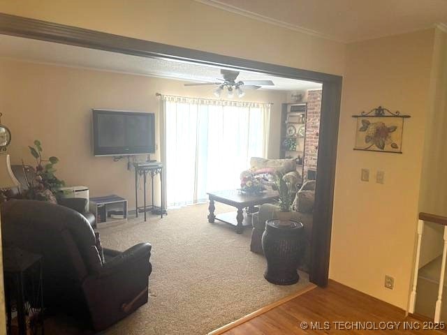 1417 Leisure Rd, Grove, OK 74344 - living area with crown molding, ceiling fan, and wood finished floors