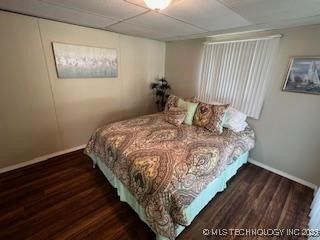 1417 Leisure Rd, Grove, OK 74344 - bedroom with wood finished floors and baseboards
