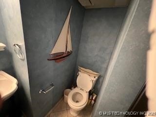 1417 Leisure Rd, Grove, OK 74344 - bathroom with tile patterned flooring and toilet
