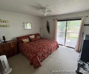 1417 Leisure Rd, Grove, OK 74344 - bedroom with access to outside, a ceiling fan, and a textured ceiling