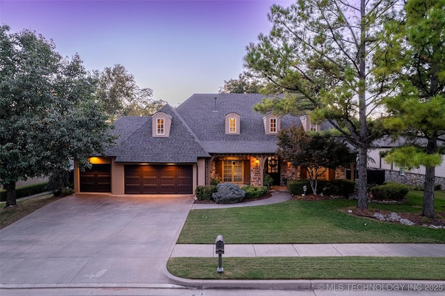 10942 S 93rd E Ave, Bixby, OK 74133 - view of front of house with a garage, a yard, driveway, a shingled roof, and stone siding