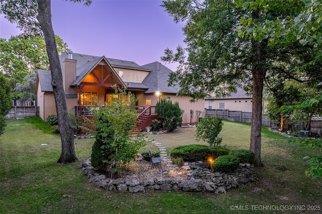 10942 S 93rd E Ave, Bixby, OK 74133 - view of front of home featuring stairs, a chimney, stucco siding, and a wooden deck