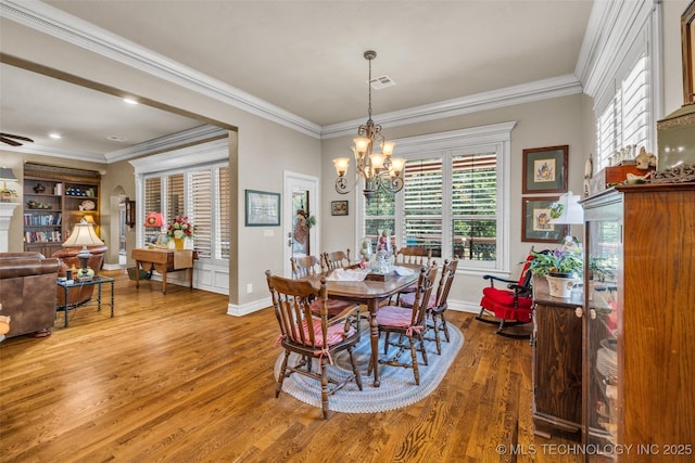 10942 S 93rd E Ave, Bixby, OK 74133 - dining space with wood finished floors, a chandelier, baseboards, and crown molding