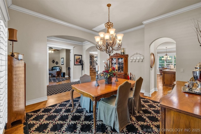 10942 S 93rd E Ave, Bixby, OK 74133 - dining area featuring arched walkways, a chandelier, wood finished floors, and ornamental molding
