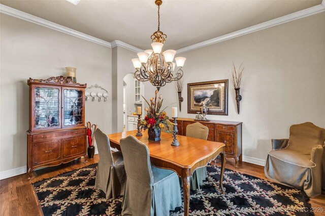 10942 S 93rd E Ave, Bixby, OK 74133 - dining room with a chandelier, crown molding, arched walkways, dark wood-style flooring, and baseboards