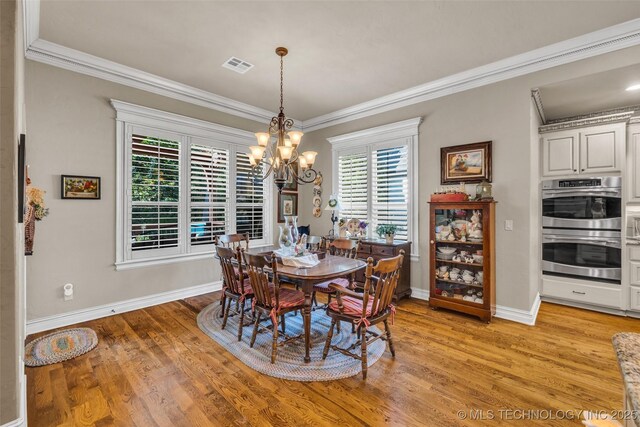 10942 S 93rd E Ave, Bixby, OK 74133 - dining space featuring a chandelier, ornamental molding, baseboards, and light wood-style floors