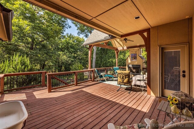 10942 S 93rd E Ave, Bixby, OK 74133 - deck with ceiling fan and an outdoor living space with a fireplace