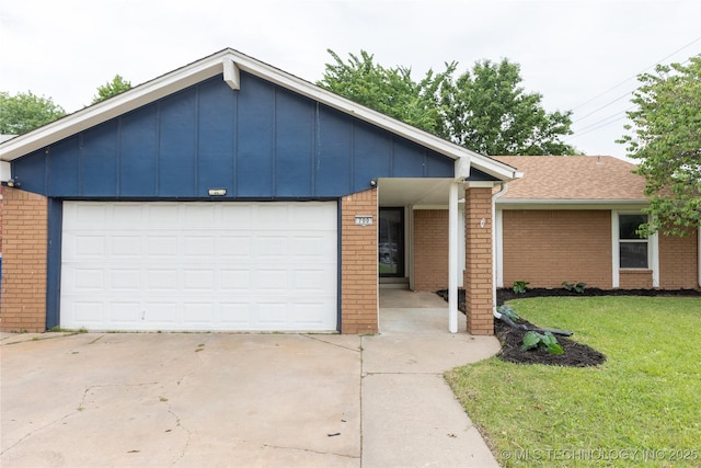 view of front of house featuring brick siding, a front lawn, and a garage