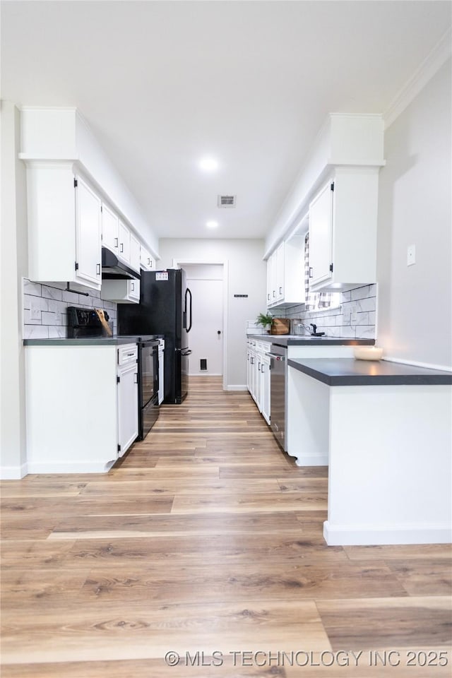 kitchen with stainless steel dishwasher, under cabinet range hood, dark countertops, decorative backsplash, and recessed lighting