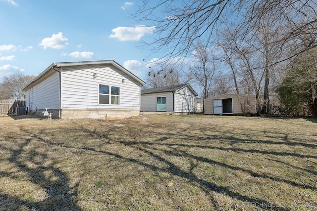 523 W Toledo Pl, Broken Arrow, OK 74012 - rear view of property featuring a yard and an outbuilding
