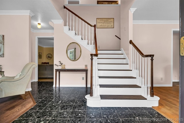 stairs featuring crown molding and baseboards