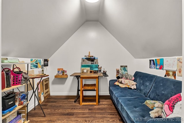 living area featuring wood finished floors, lofted ceiling, and baseboards