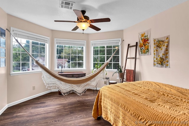 bedroom featuring dark wood-style flooring, baseboards, and ceiling fan