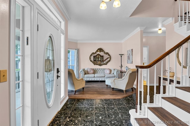 foyer featuring stairway and crown molding