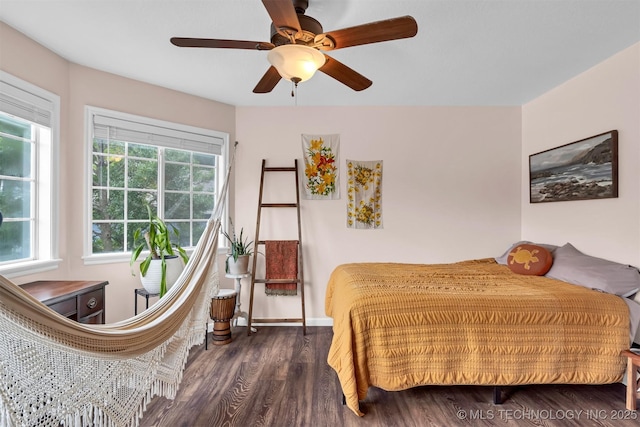 bedroom featuring wood finished floors, ceiling fan, and baseboards