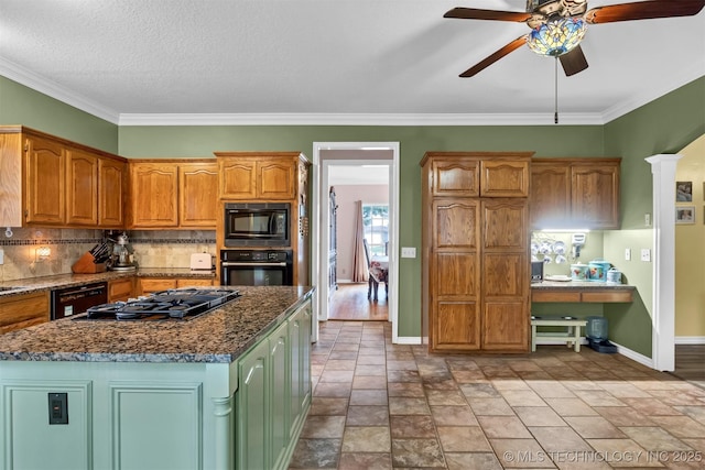 kitchen with black appliances, baseboards, a ceiling fan, backsplash, and dark stone countertops