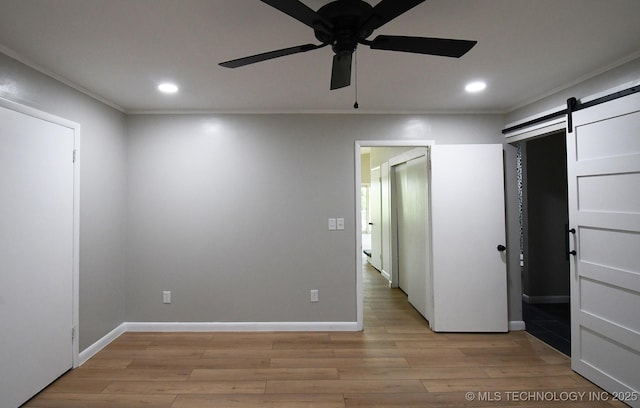 96358 S 4531, Vian, OK 74962 - unfurnished bedroom with a barn door, recessed lighting, light wood finished floors, baseboards, and ornamental molding