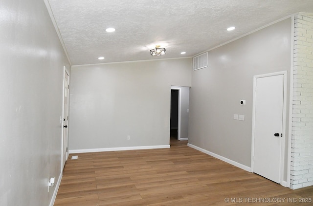 96358 S 4531, Vian, OK 74962 - spare room with a textured ceiling, light wood-style floors, recessed lighting, ornamental molding, and baseboards
