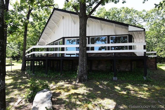 96358 S 4531, Vian, OK 74962 - view of front facade with a wooden deck and board and batten siding