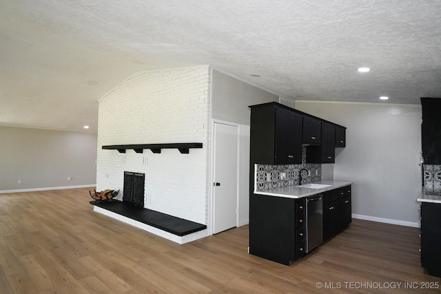96358 S 4531, Vian, OK 74962 - kitchen with dark cabinets, dishwashing machine, light countertops, wood finished floors, and vaulted ceiling