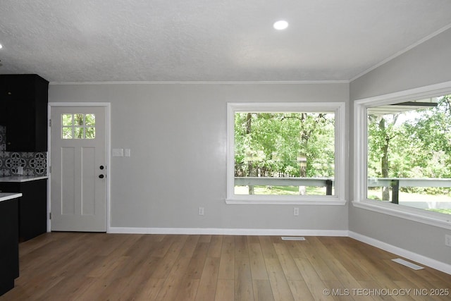 96358 S 4531, Vian, OK 74962 - unfurnished living room with baseboards, wood finished floors, ornamental molding, and recessed lighting
