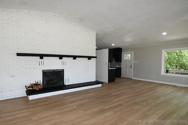 96358 S 4531, Vian, OK 74962 - unfurnished living room with wood finished floors, baseboards, a fireplace, lofted ceiling, and a textured ceiling