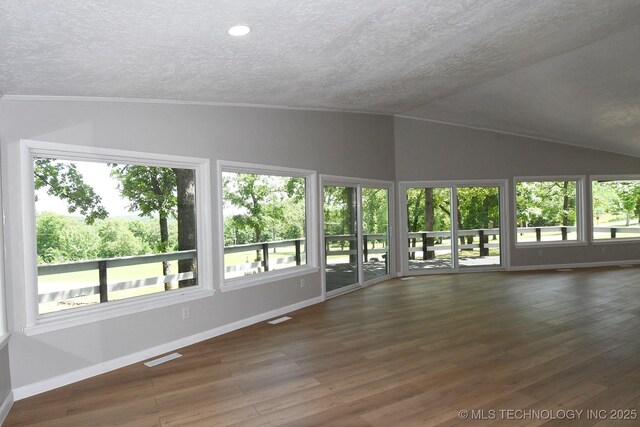 96358 S 4531, Vian, OK 74962 - unfurnished living room with lofted ceiling, a textured ceiling, hardwood / wood-style floors, ornamental molding, and baseboards