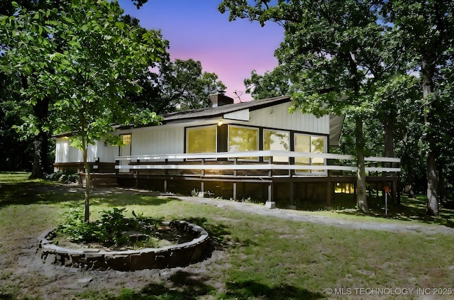 96358 S 4531, Vian, OK 74962 - back of property at dusk with a chimney, a deck, a yard, and a garage