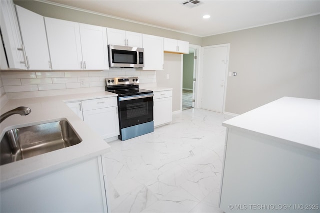 4024 E 25th St, Tulsa, OK 74114 - kitchen featuring appliances with stainless steel finishes, light marble finish flooring, a sink, backsplash, and white cabinetry