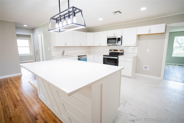 4024 E 25th St, Tulsa, OK 74114 - kitchen with appliances with stainless steel finishes, ornamental molding, a sink, baseboards, and decorative backsplash
