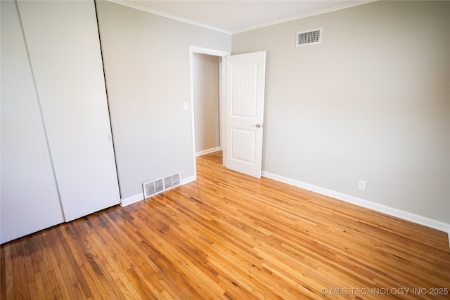 4024 E 25th St, Tulsa, OK 74114 - unfurnished bedroom with crown molding, baseboards, light wood-type flooring, and a closet