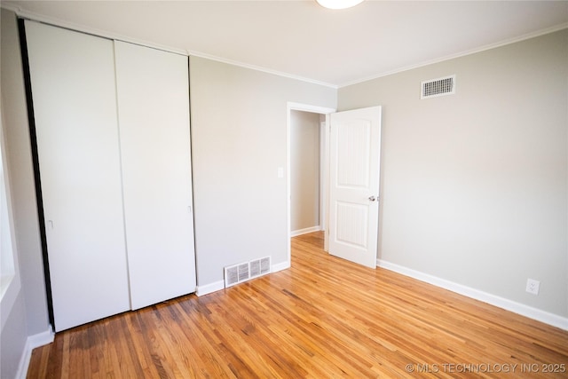 4024 E 25th St, Tulsa, OK 74114 - unfurnished bedroom with ornamental molding, a closet, wood finished floors, and baseboards
