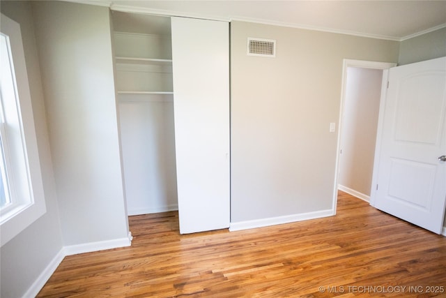 4024 E 25th St, Tulsa, OK 74114 - unfurnished bedroom with a closet, ornamental molding, wood finished floors, and baseboards