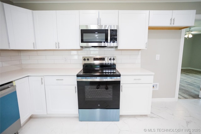 4024 E 25th St, Tulsa, OK 74114 - kitchen featuring appliances with stainless steel finishes, light marble finish flooring, baseboards, and light countertops