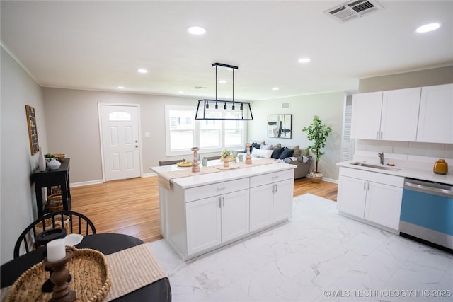 4024 E 25th St, Tulsa, OK 74114 - kitchen featuring stainless steel dishwasher, a sink, recessed lighting, light countertops, and white cabinetry